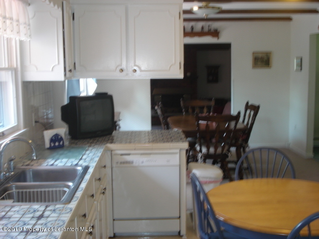 339 Maple Lake Road Moscow, PA 18444 - Photo 5 of 21 a kitchen with stainless steel appliances granite countertop a sink a stove a table and chairs