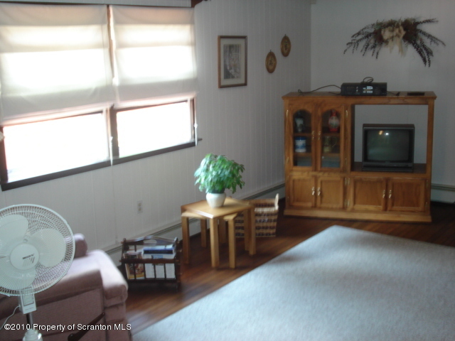 339 Maple Lake Road Moscow, PA 18444 - Photo 9 of 21 a living room with furniture a window and a fireplace