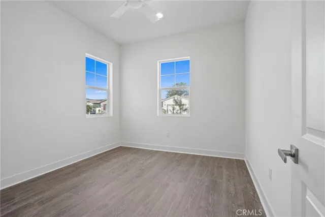 an empty room with a wooden floor and a window