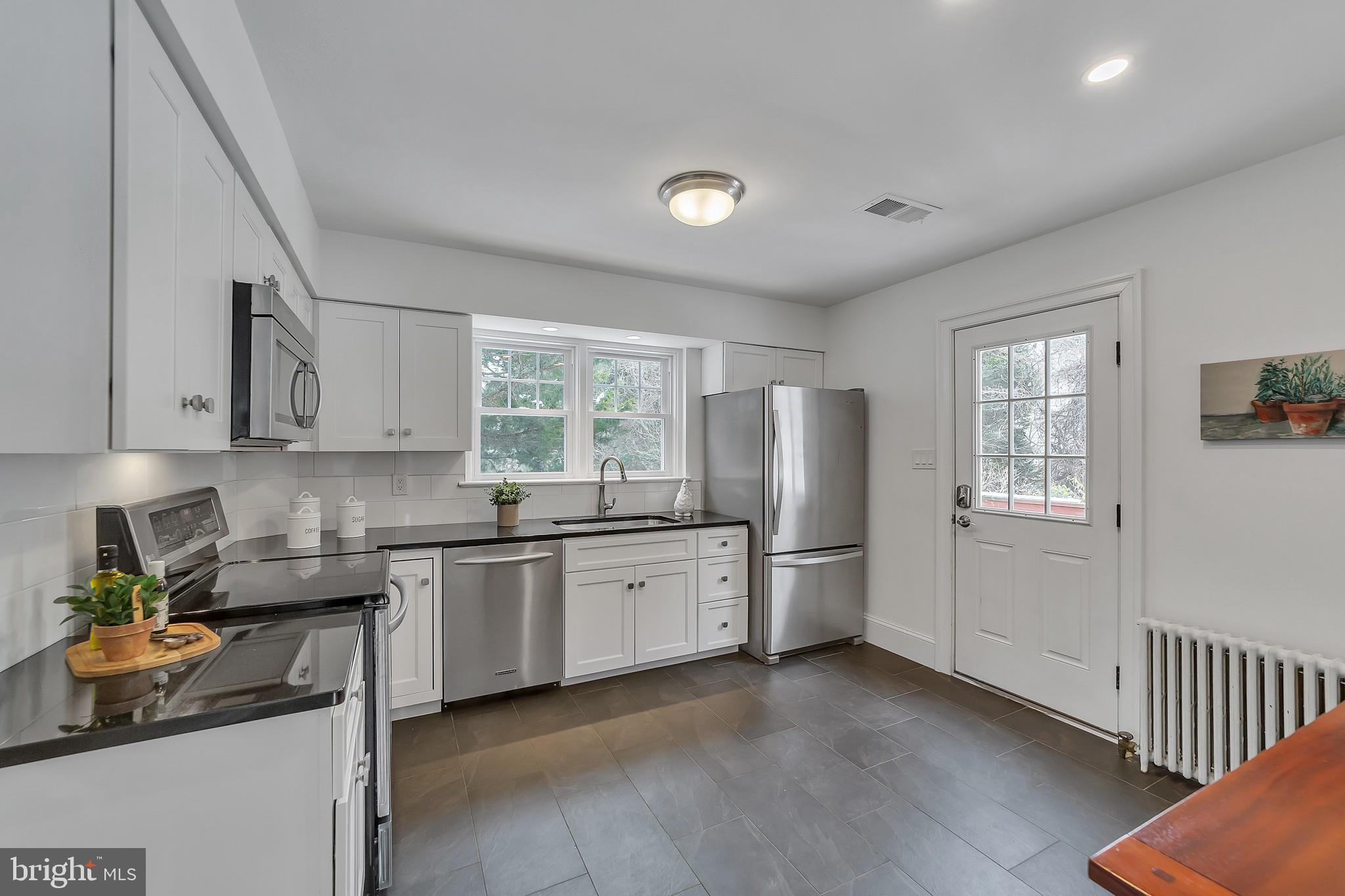 2088 Dutton Mill Road Newtown Square, PA 19073 - Photo 9 of 25 New Kitchen w/stainless appliances & door to deck.