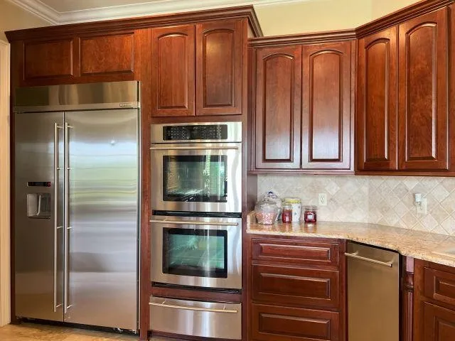 a kitchen with stainless steel appliances granite countertop a refrigerator and a sink
