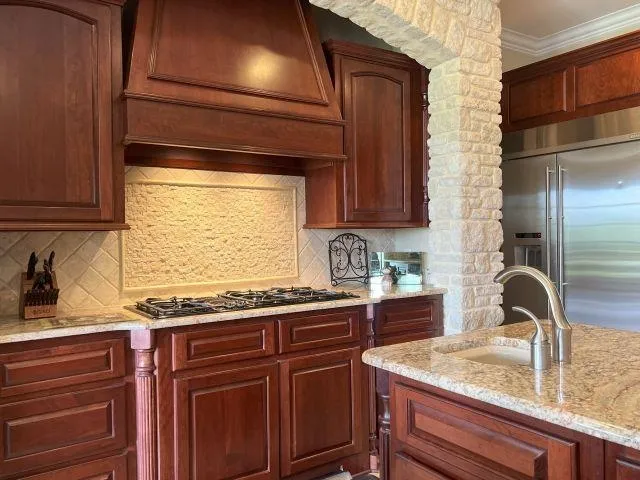 a kitchen with granite countertop stainless steel appliances and sink
