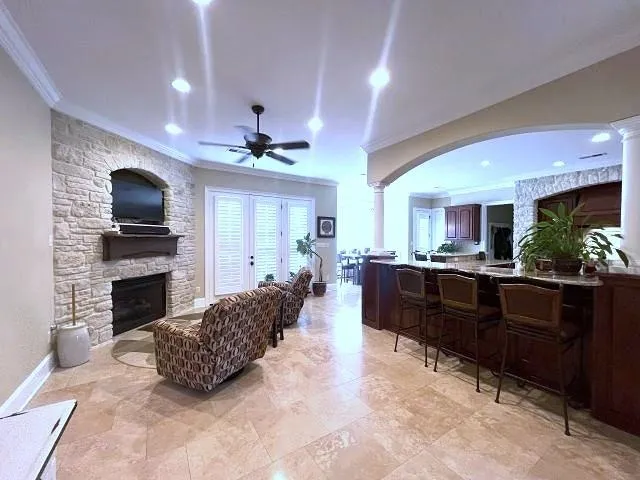 a living room with furniture a flat screen tv and a fireplace