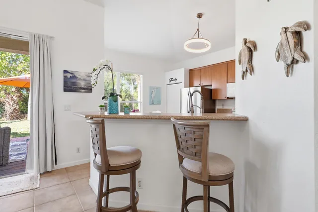 a kitchen with stainless steel appliances a table and chairs