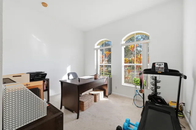 a view of hall way with furniture and windows