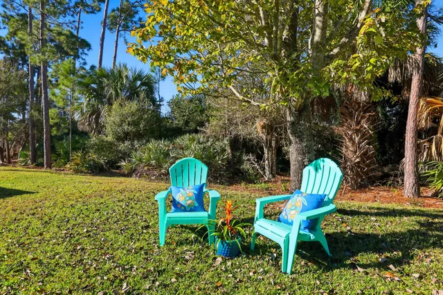 a backyard of a house with table and chairs