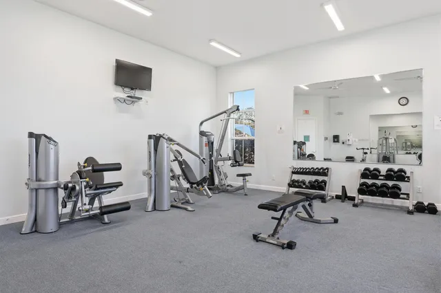 a view of a livingroom with gym equipment