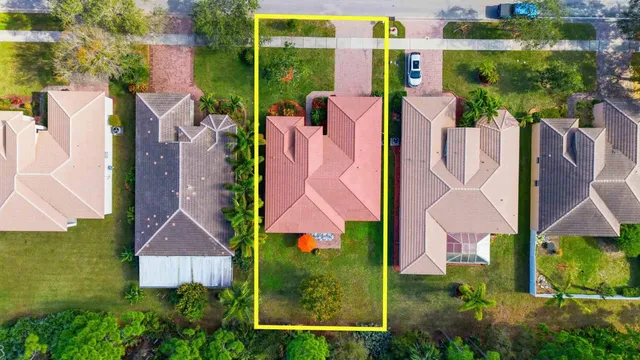 an aerial view of multiple houses with a yard