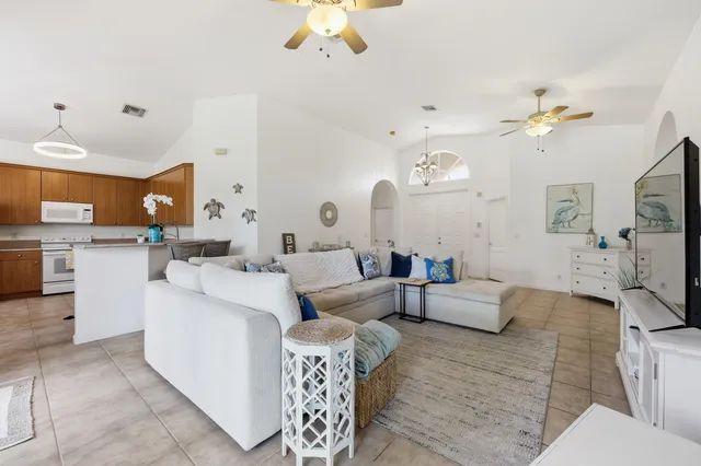 a living room with furniture and a chandelier
