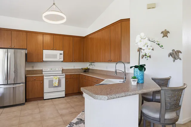 a kitchen with granite countertop a sink stainless steel appliances and cabinets