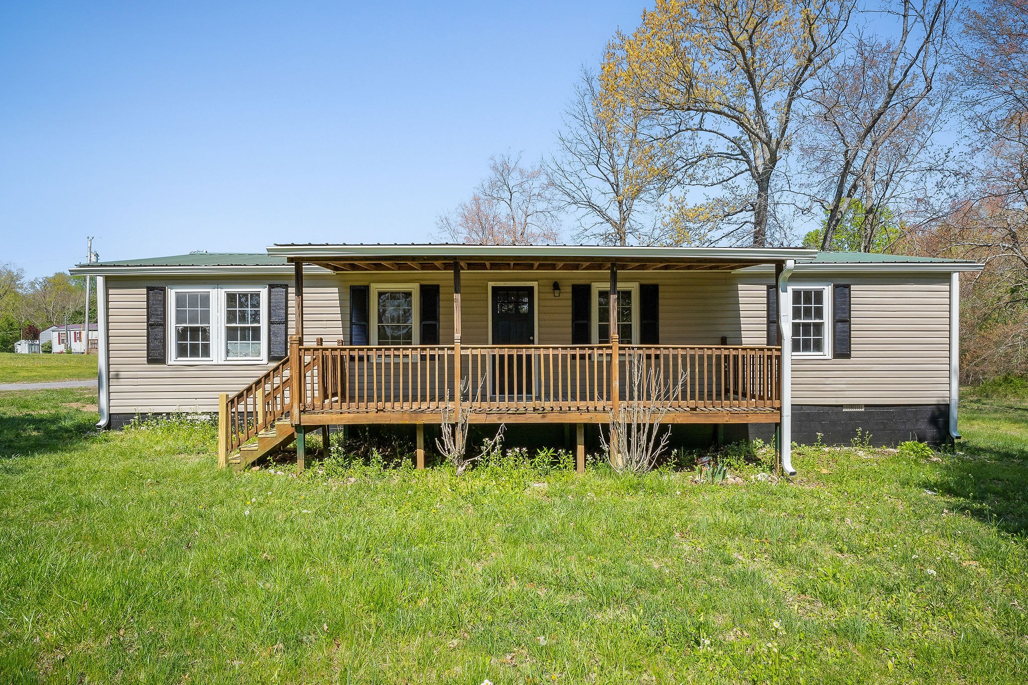 a view of a house with yard and sitting area