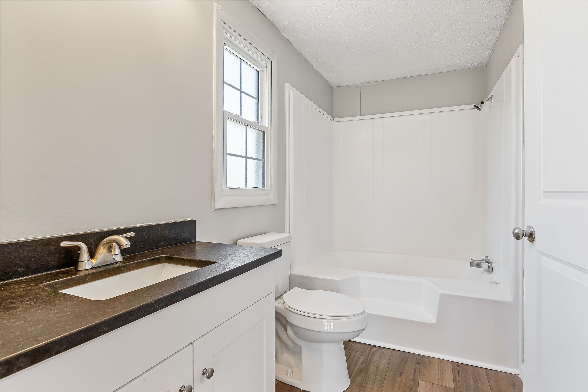 689 Capshaw Road Smithville, TN 37166 - Photo 14 of 29 a bathroom with a granite countertop sink a toilet and shower