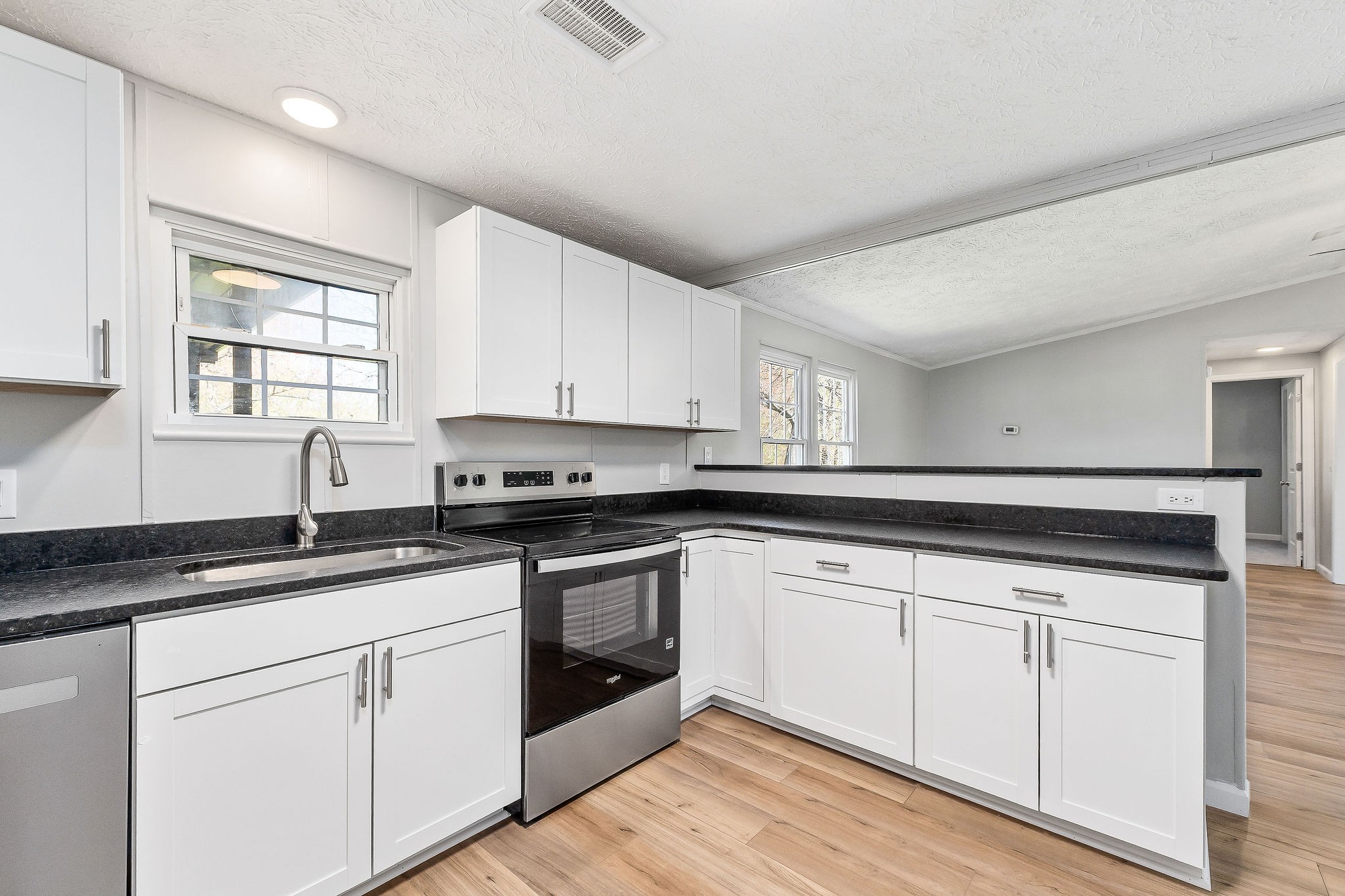 689 Capshaw Road Smithville, TN 37166 - Photo 21 of 29 a kitchen with granite countertop white cabinets and white appliances