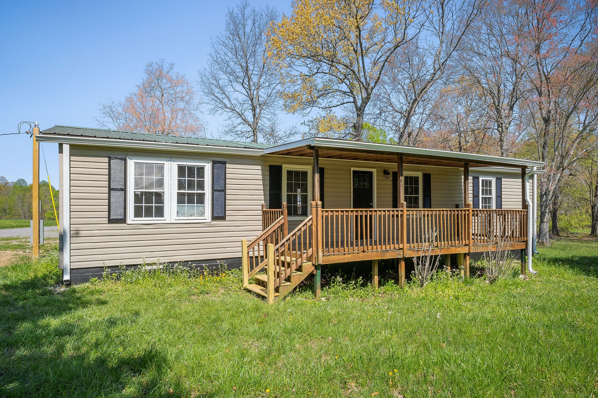 689 Capshaw Road Smithville, TN 37166 - Photo 23 of 29 a view of a house with a backyard and wooden deck
