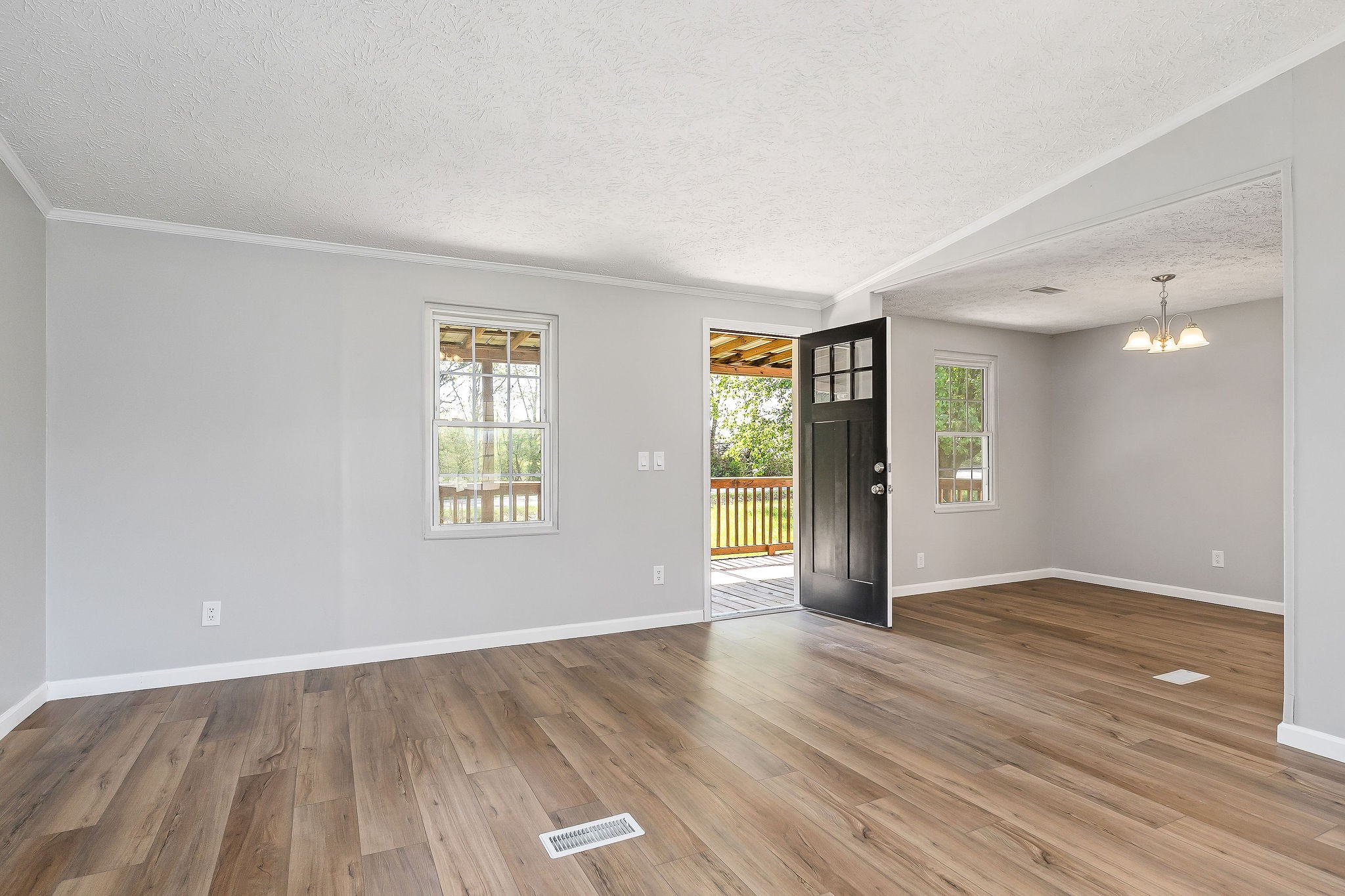 689 Capshaw Road Smithville, TN 37166 - Photo 3 of 29 an empty room with wooden floor and windows