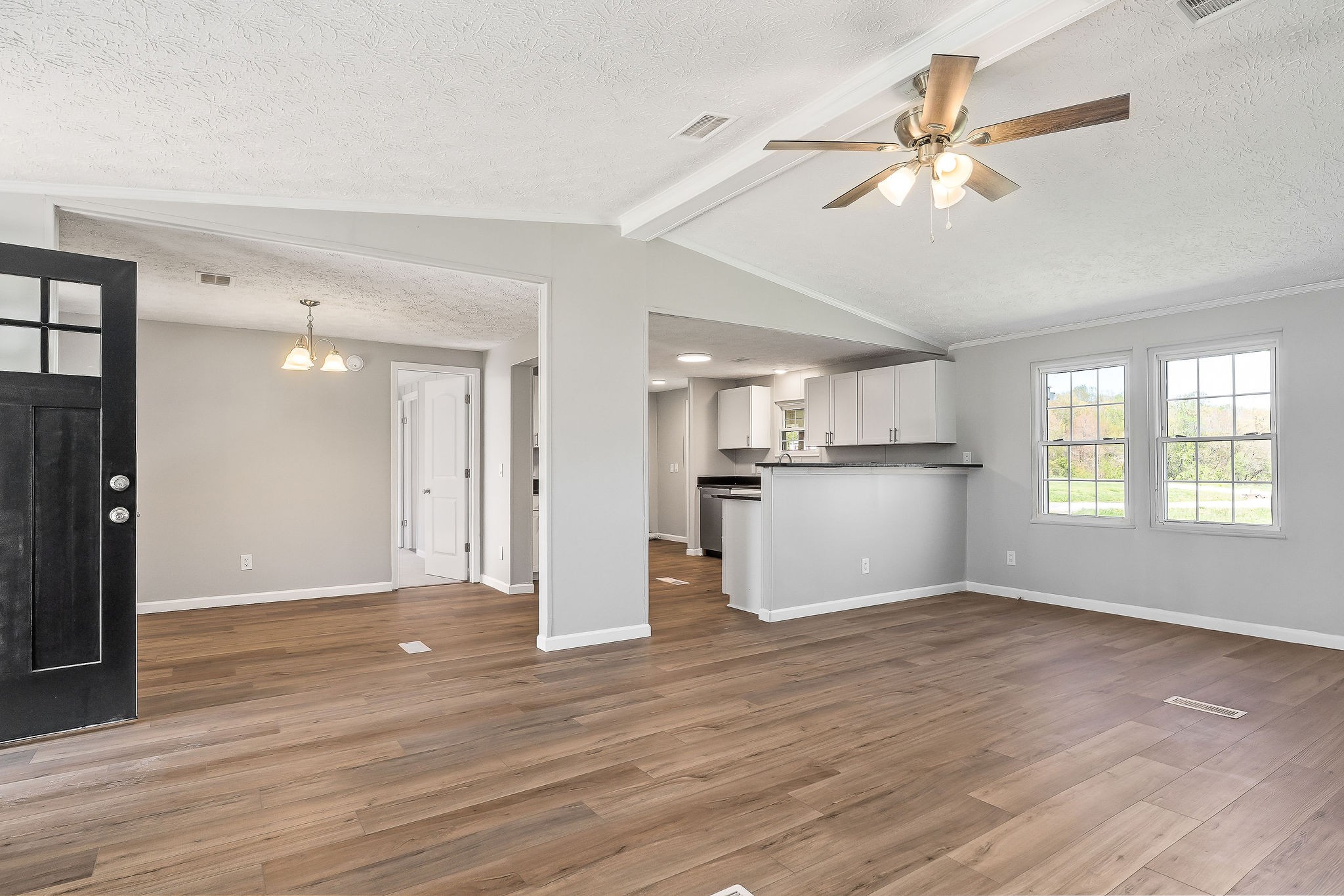 689 Capshaw Road Smithville, TN 37166 - Photo 4 of 29 a view of a kitchen with wooden floor and a ceiling fan