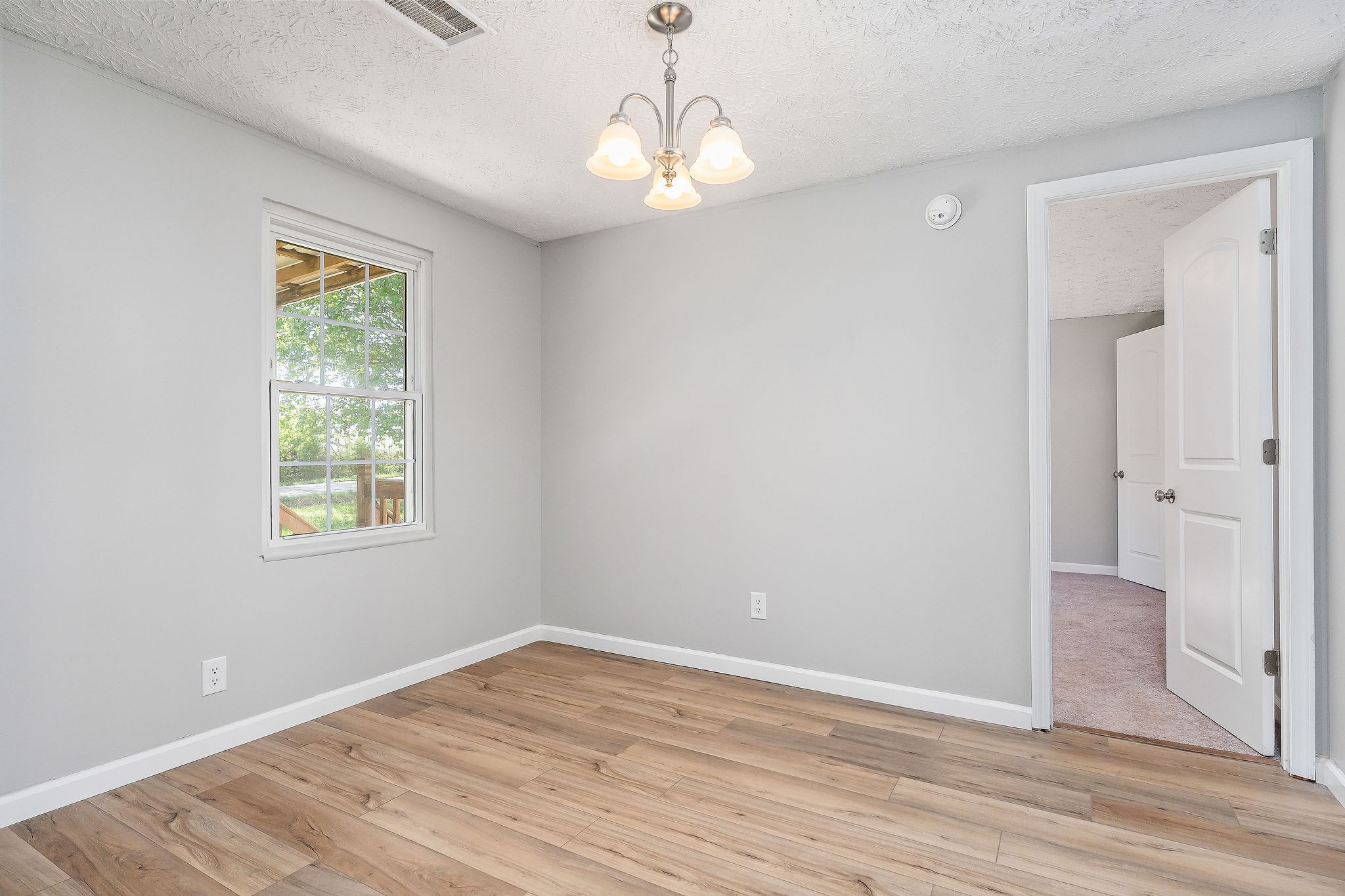689 Capshaw Road Smithville, TN 37166 - Photo 5 of 29 a view of empty room with wooden floor and fan