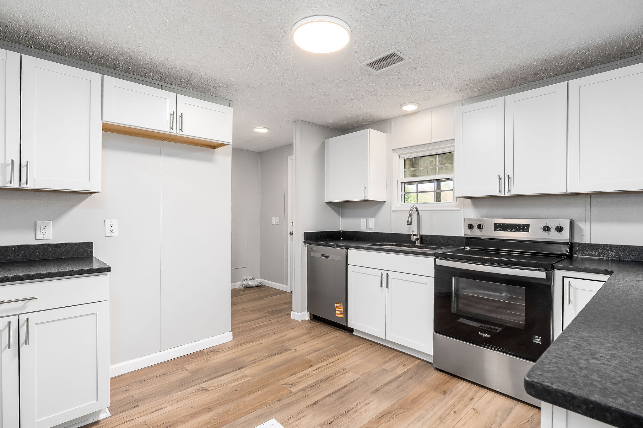 689 Capshaw Road Smithville, TN 37166 - Photo 7 of 29 a kitchen with granite countertop wooden cabinets and a stove