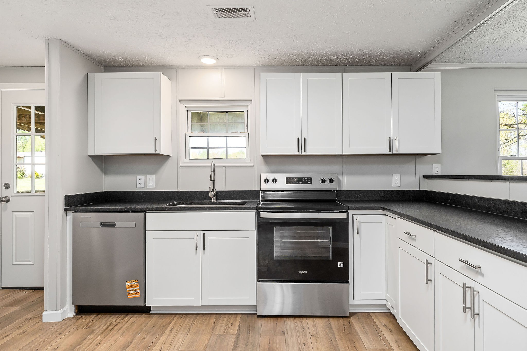 689 Capshaw Road Smithville, TN 37166 - Photo 8 of 29 a kitchen with granite countertop white cabinets and white appliances