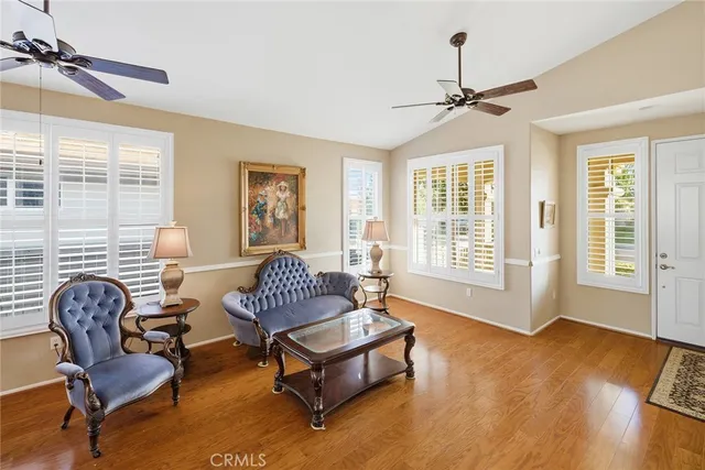 a living room with furniture a rug and a window