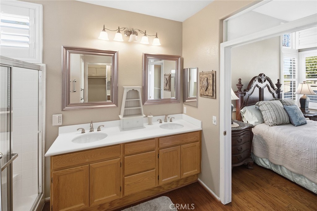 28920 Raintree Drive Menifee, CA 92584 - Photo 33 of 51 a en suite bathroom with a double vanity sink and a mirror
