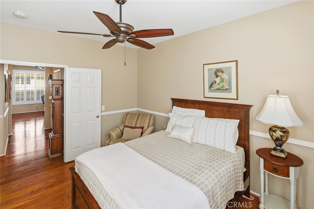 28920 Raintree Drive Menifee, CA 92584 - Photo 43 of 51 a bedroom with a bed and wooden floor
