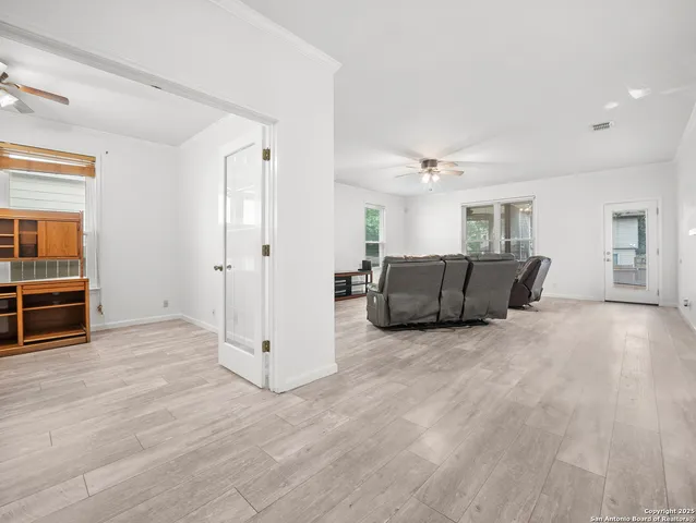 a view of a livingroom with furniture and an empty room