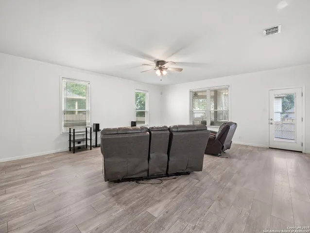 a living room with furniture and wooden floor