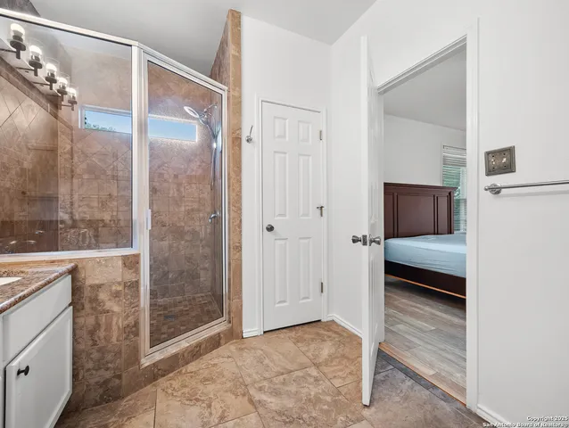 a bathroom with a shower and a sink
