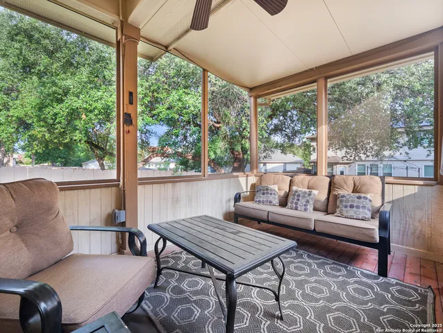 a living room with furniture and a floor to ceiling window