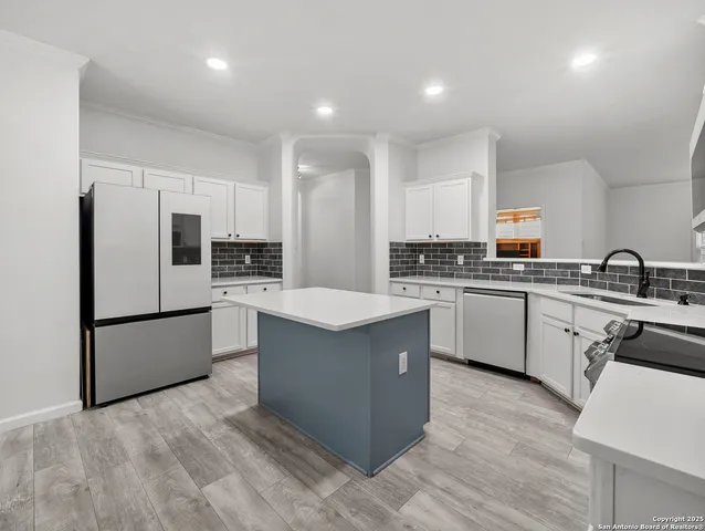 a kitchen with a cabinets and a stove top oven