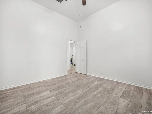 a view of an empty room with wooden floor