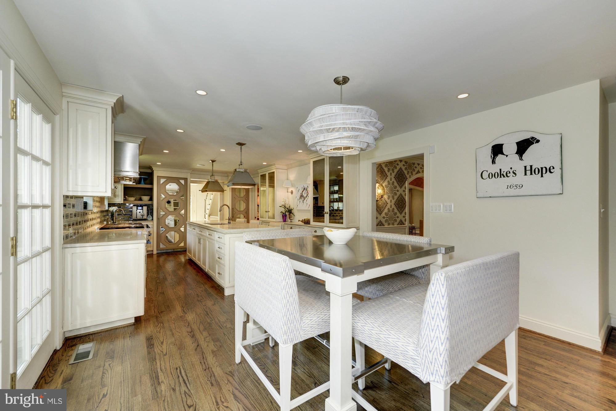 2206 Windsor Road Alexandria, VA 22307 - Photo 7 of 30 a kitchen with kitchen island stainless steel appliances a dining table and chairs