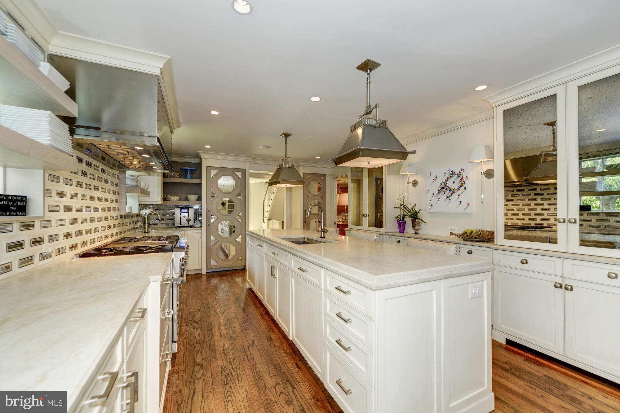 2206 Windsor Road Alexandria, VA 22307 - Photo 9 of 30 a large kitchen with stainless steel appliances a lot of counter space and a wooden floors