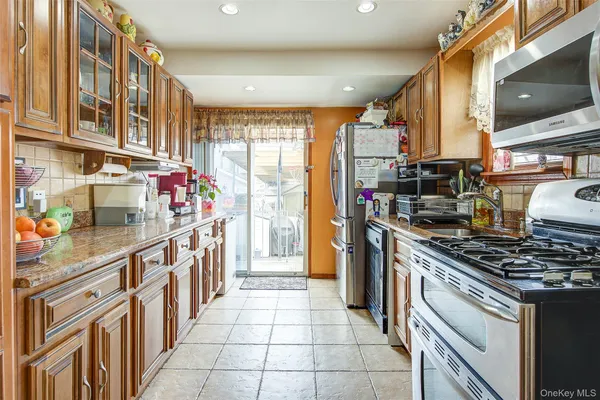 a kitchen with stainless steel appliances granite countertop a stove and a sink