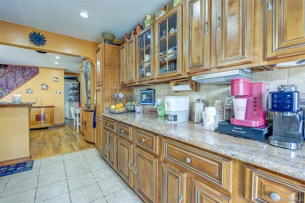 a kitchen with stainless steel appliances granite countertop a sink and cabinets