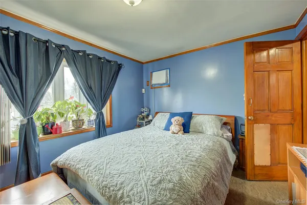 a bed sitting in a bedroom next to a window