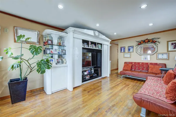 a living room with furniture lamp and potted plant