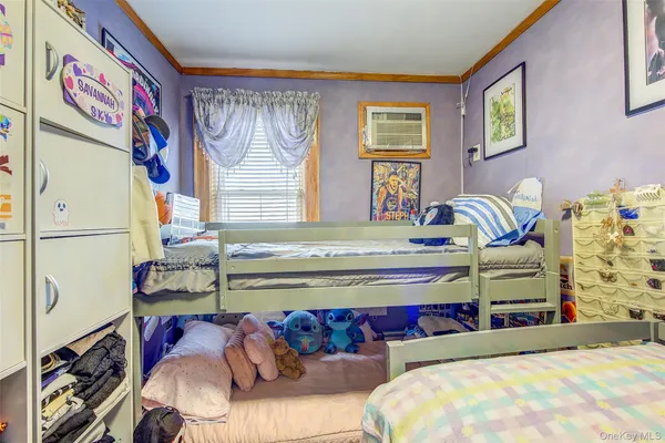 a bedroom with furniture and a book shelf