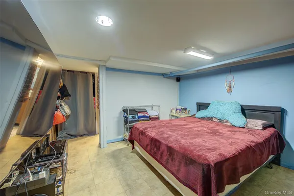 a bedroom with a bed and a television