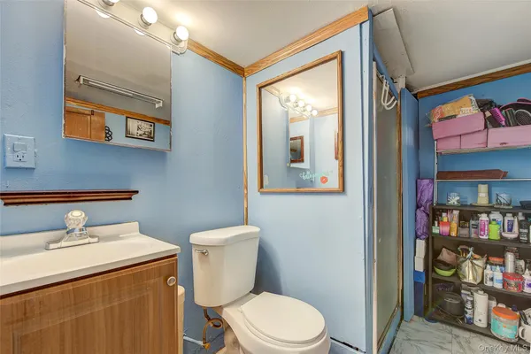 a white toilet sitting next to a bathroom sink