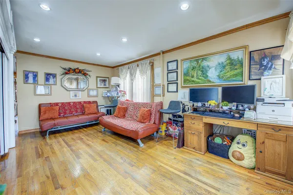 a bedroom with furniture and a large window
