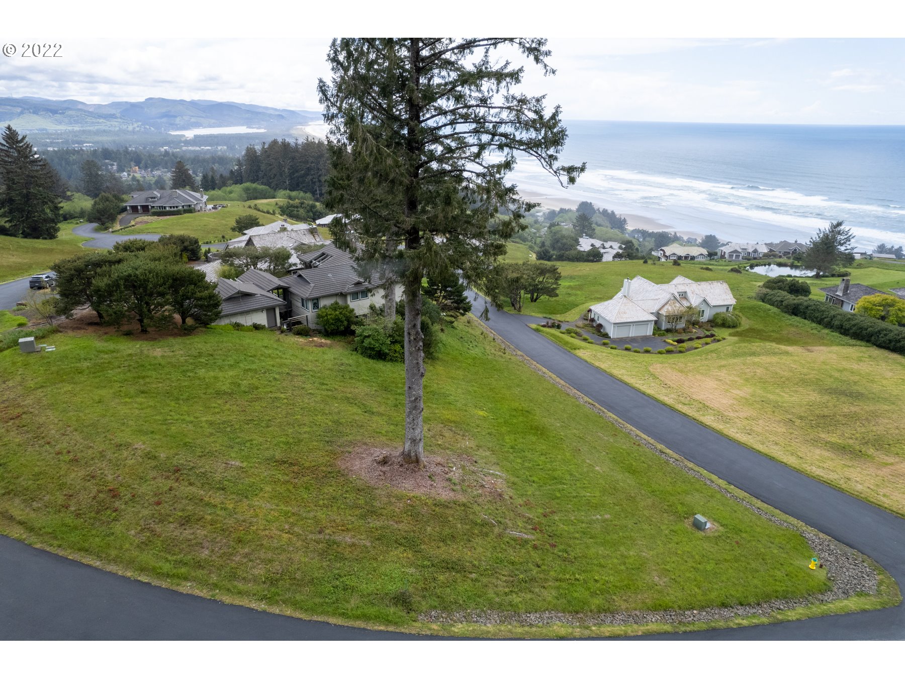 Braeridge Drive, Unit 10 Nehalem, OR 97131 - Photo 2 of 26 a view of a lake with a mountain