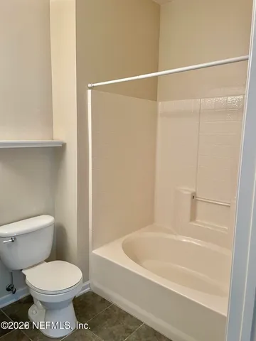 a bathroom with a toilet and a bathtub