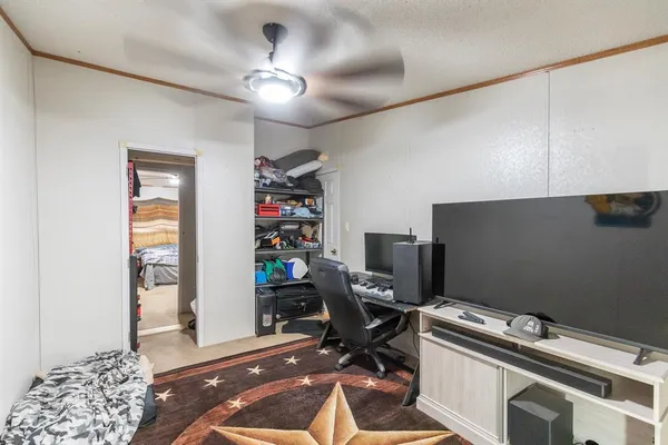 a bed room with a bed and a ceiling fan