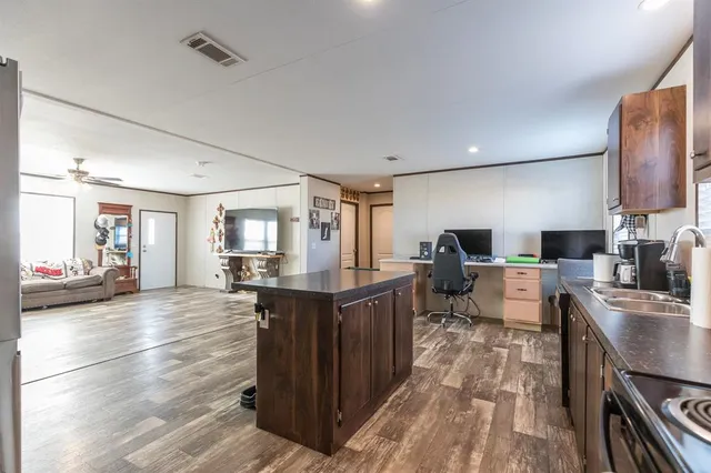 a kitchen with stainless steel appliances granite countertop a stove refrigerator and cabinets