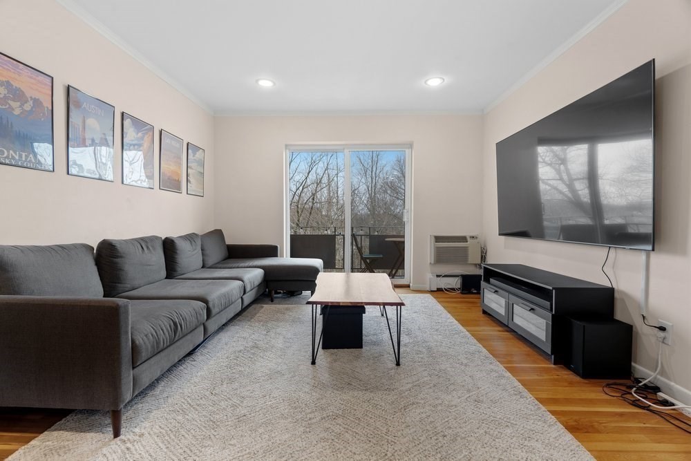 135 Granite Avenue, Unit 49 Boston, MA 02124 - Photo 1 of 14 a living room with furniture and a flat screen tv