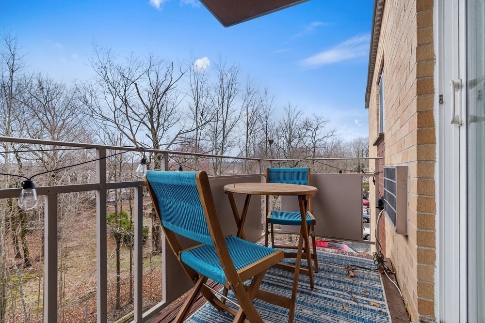 135 Granite Avenue, Unit 49 Boston, MA 02124 - Photo 11 of 14 a view of a balcony with chairs