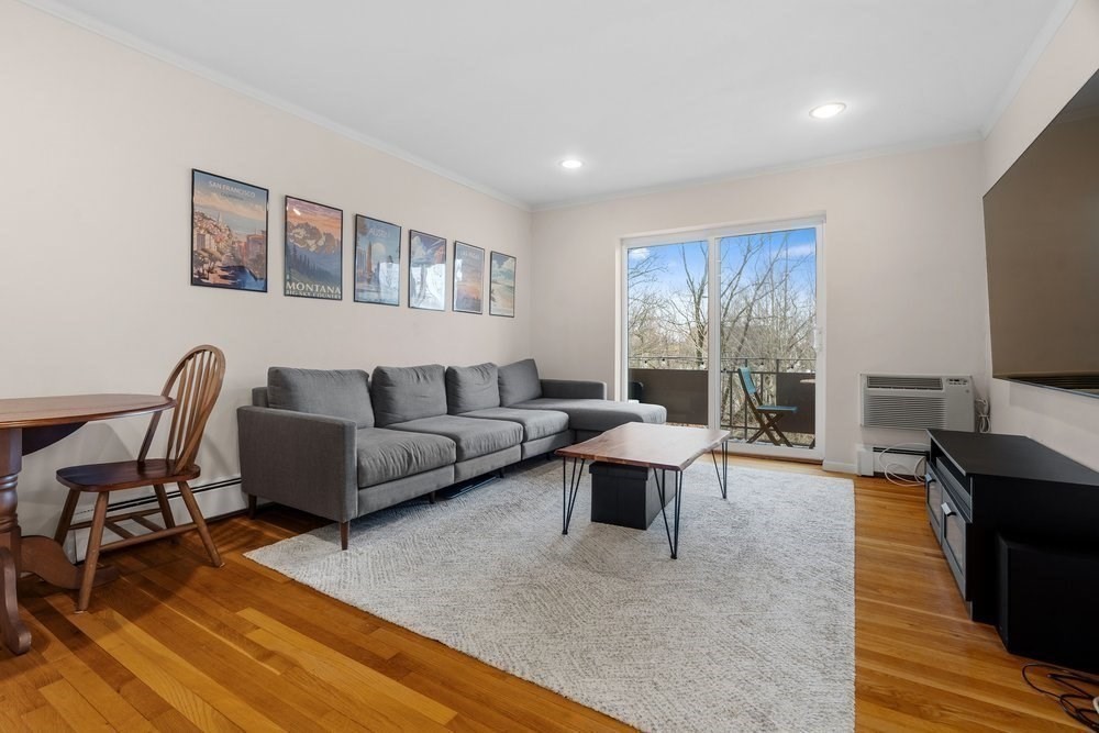 135 Granite Avenue, Unit 49 Boston, MA 02124 - Photo 2 of 14 a living room with furniture and a flat screen tv
