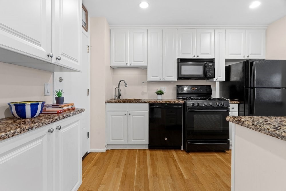 135 Granite Avenue, Unit 49 Boston, MA 02124 - Photo 5 of 14 a kitchen with stainless steel appliances granite countertop a sink stove refrigerator and cabinets